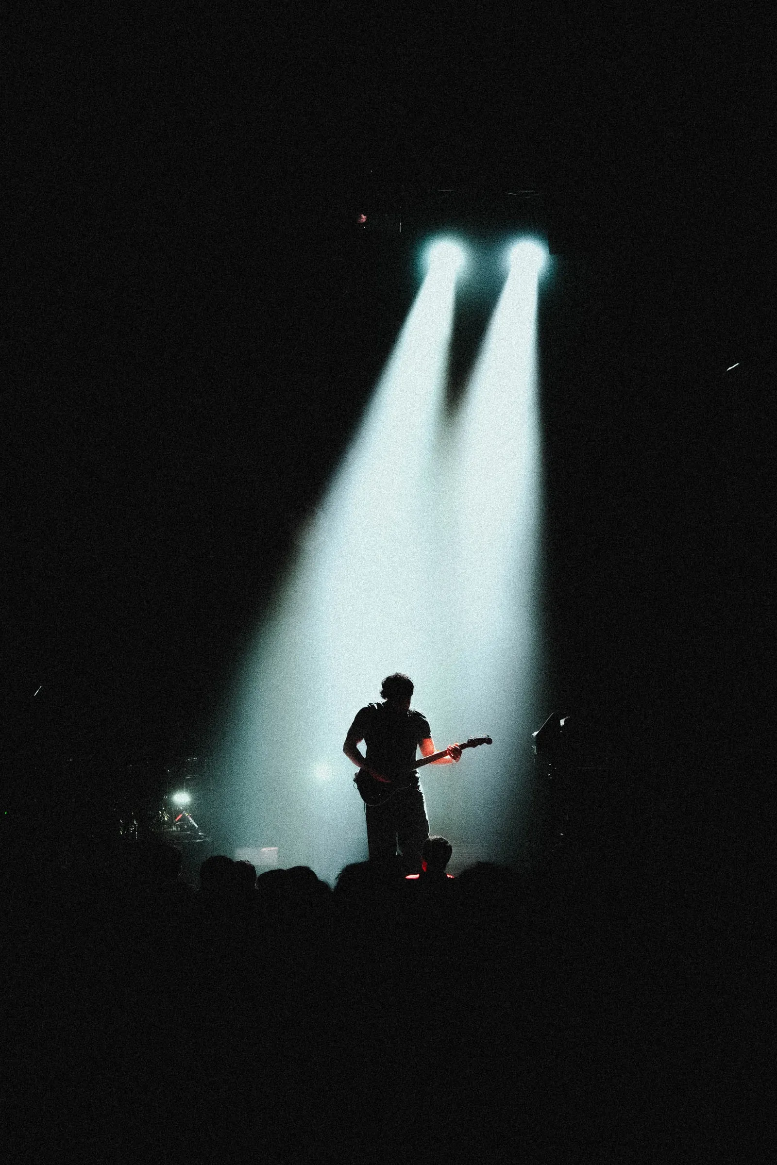 Amin Mortada performing live, silhouetted against stage lights